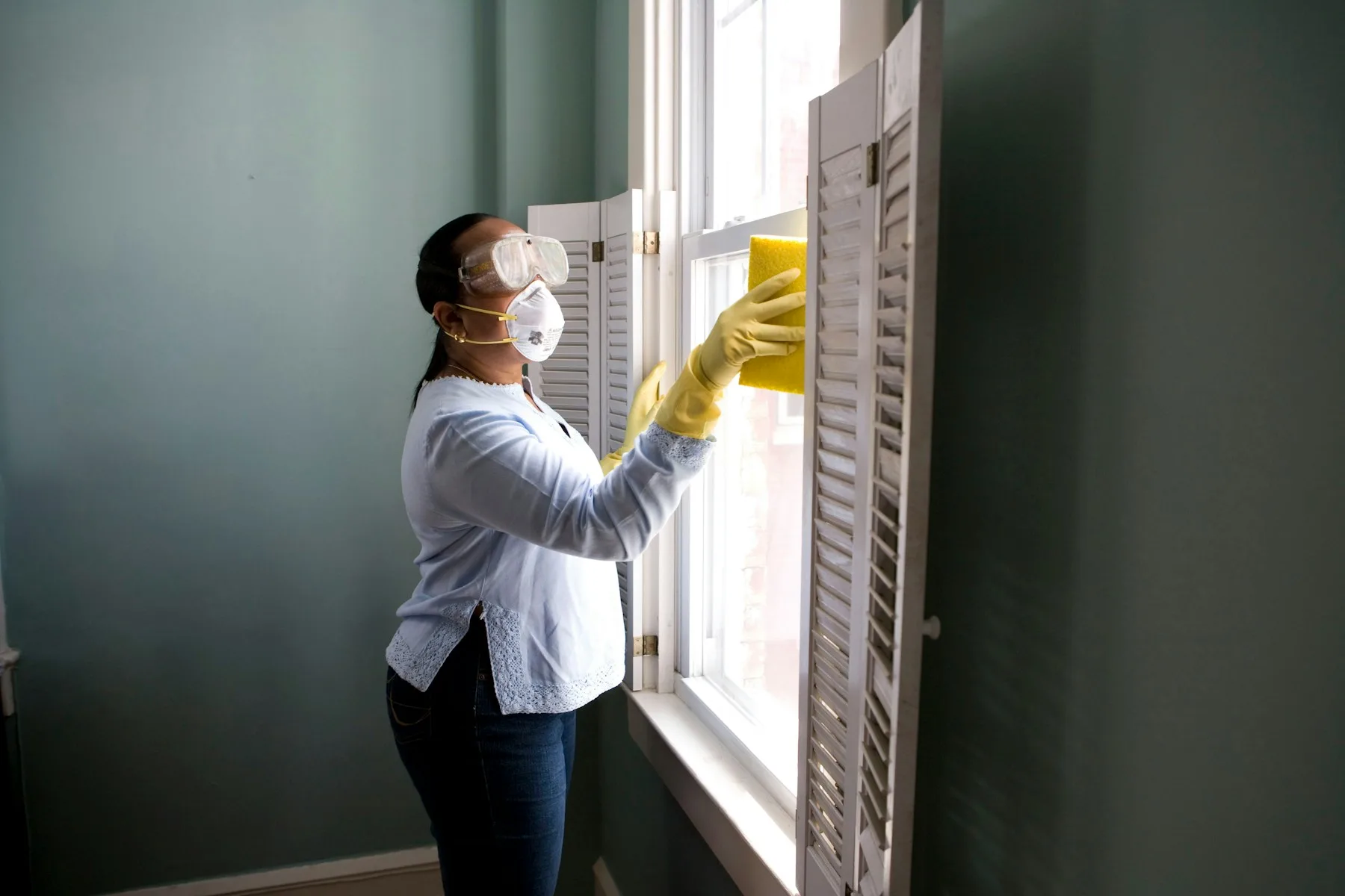 A bright kitchen being cleaned with a cloth